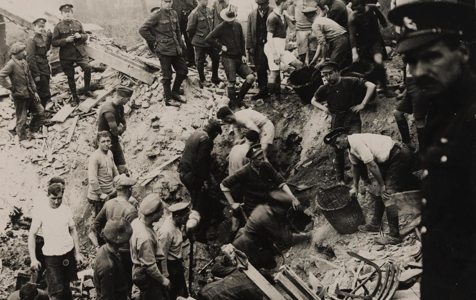 Photographie noir et blanc montrant des hommes en train de déblayer des gravas.